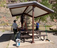 Volunteers apply fresh paint to picnic shelters, during the National Public Lands Day event at Abiquiu Lake, N.M., Sept. 25, 2021